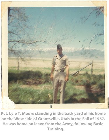 Pvt Lyle T. Moore standing in the backyard of his home on the West side of Grantsville, Utah in the Fall of 1967. He was home on leave from the Army, following Basic Training